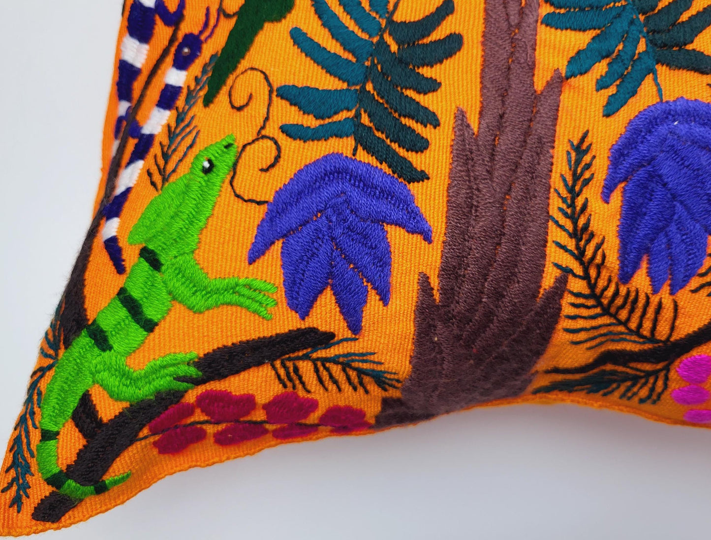 Hand embroidered and woven Mexican cushion cover with vibrant animal patterns
