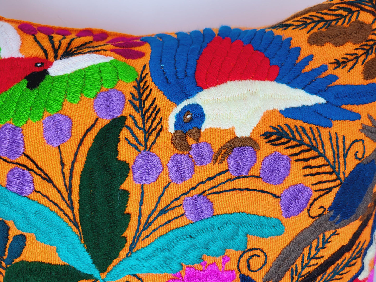 Hand embroidered and woven Mexican cushion cover with vibrant animal patterns