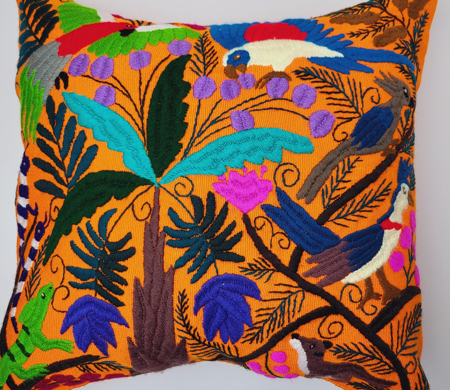 Hand embroidered and woven Mexican cushion cover with vibrant animal patterns