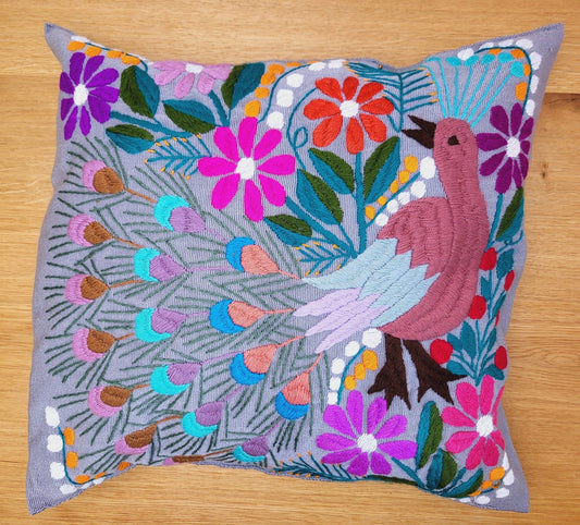 decorative pillow featuring a vibrant peacock pattern, with intricate details and rich colors that highlight the beauty of the design