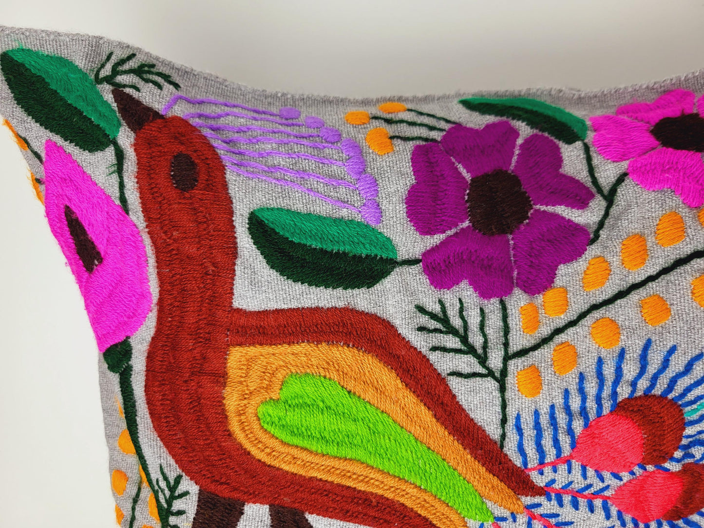 Handmade cushion cover from Mexico – artfully embroidered and woven with an enchanting animal motif.